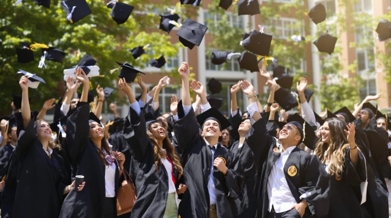 Graduates throwing caps in the air
