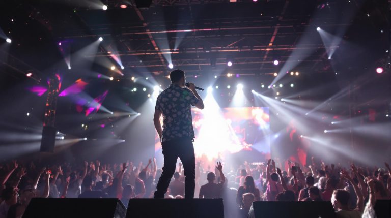 Singer performing on stage in front of a crowd.