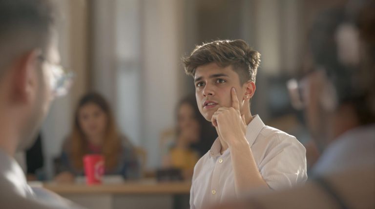Young man listening attentively in a meeting.